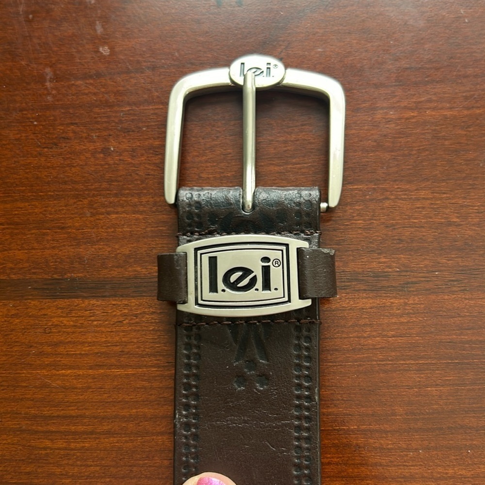 Genuine leather size small belt tooled with l.e.i. On buckle & on return loop.